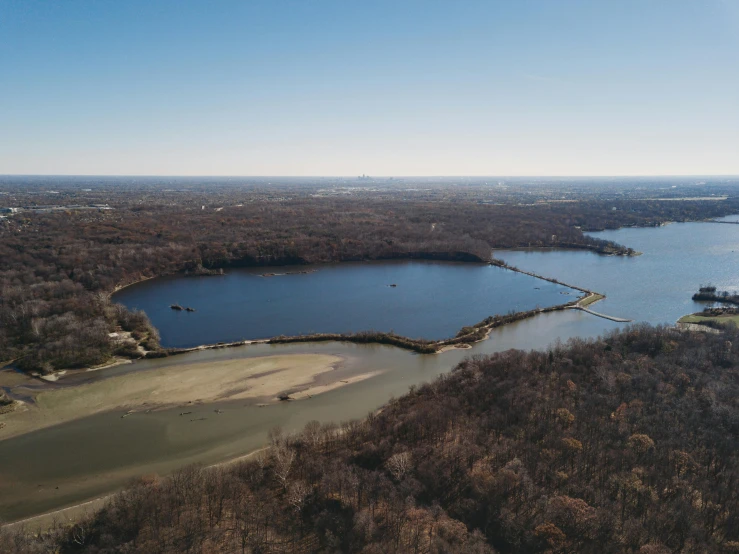 a bird's eye view of the lake surrounded by lots of trees