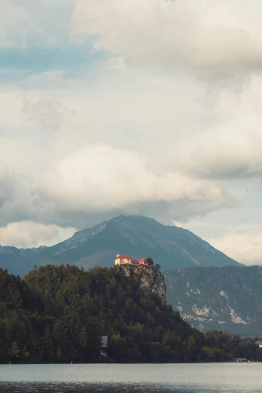 a castle is perched on a small rock