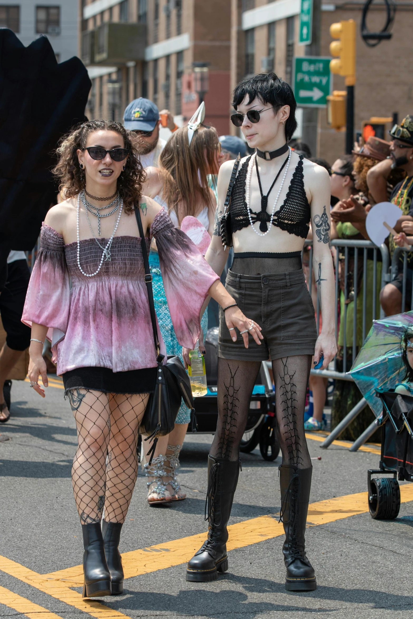 two girls walk down the street at an event