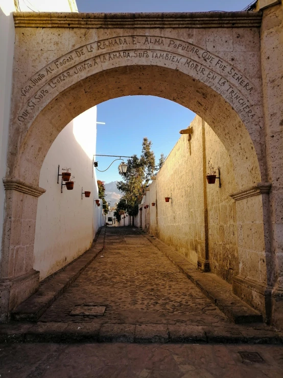 an old brick and stone archway leading to the street