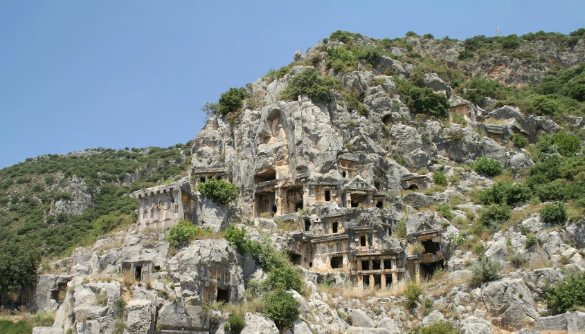 a close up view of rocks and caves on a mountain