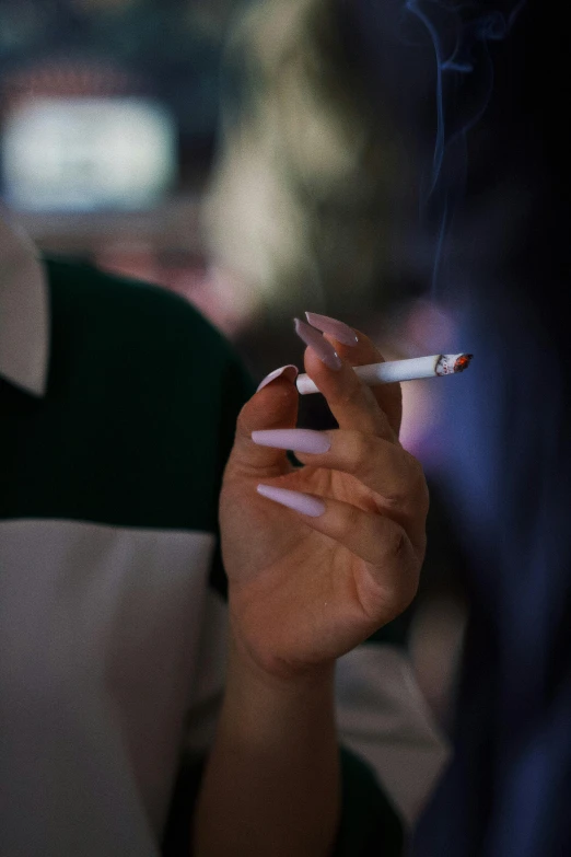 woman smoking cigarette in front of camera