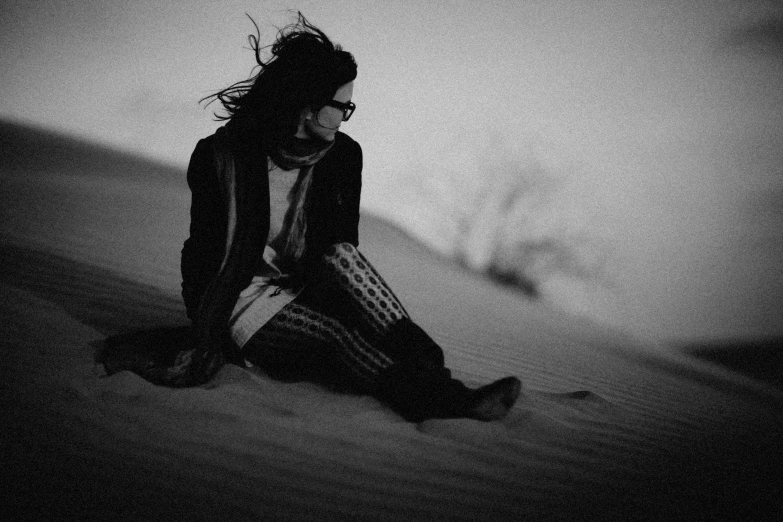 a woman with dreadlocks sitting in the snow