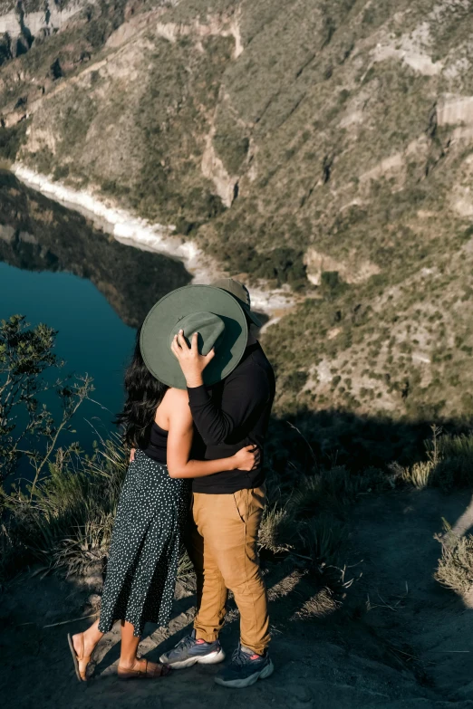 two people emcing on top of a mountain