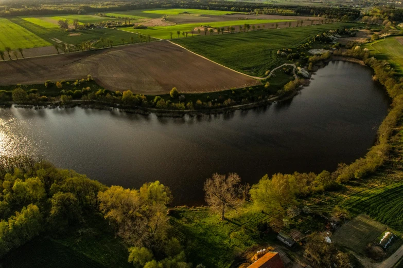 the river runs beside the green countryside