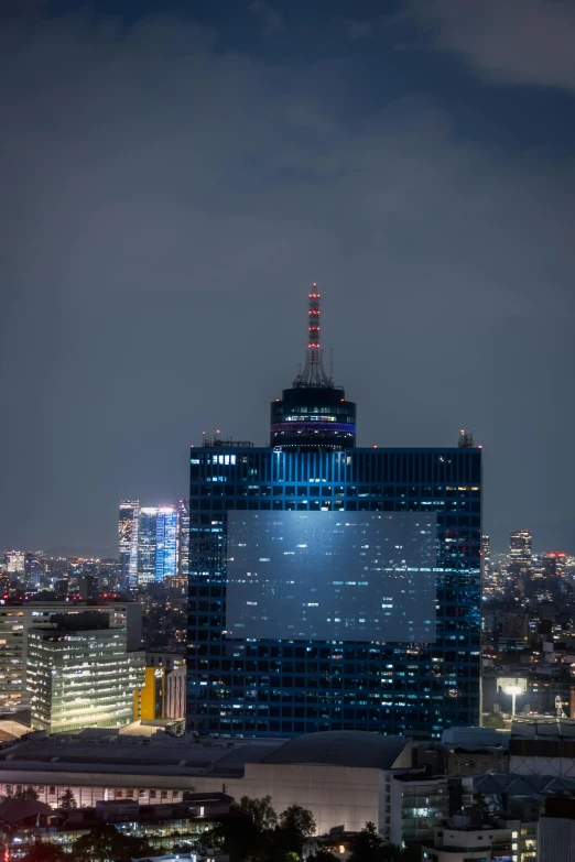 a large tall building with a bright light on top