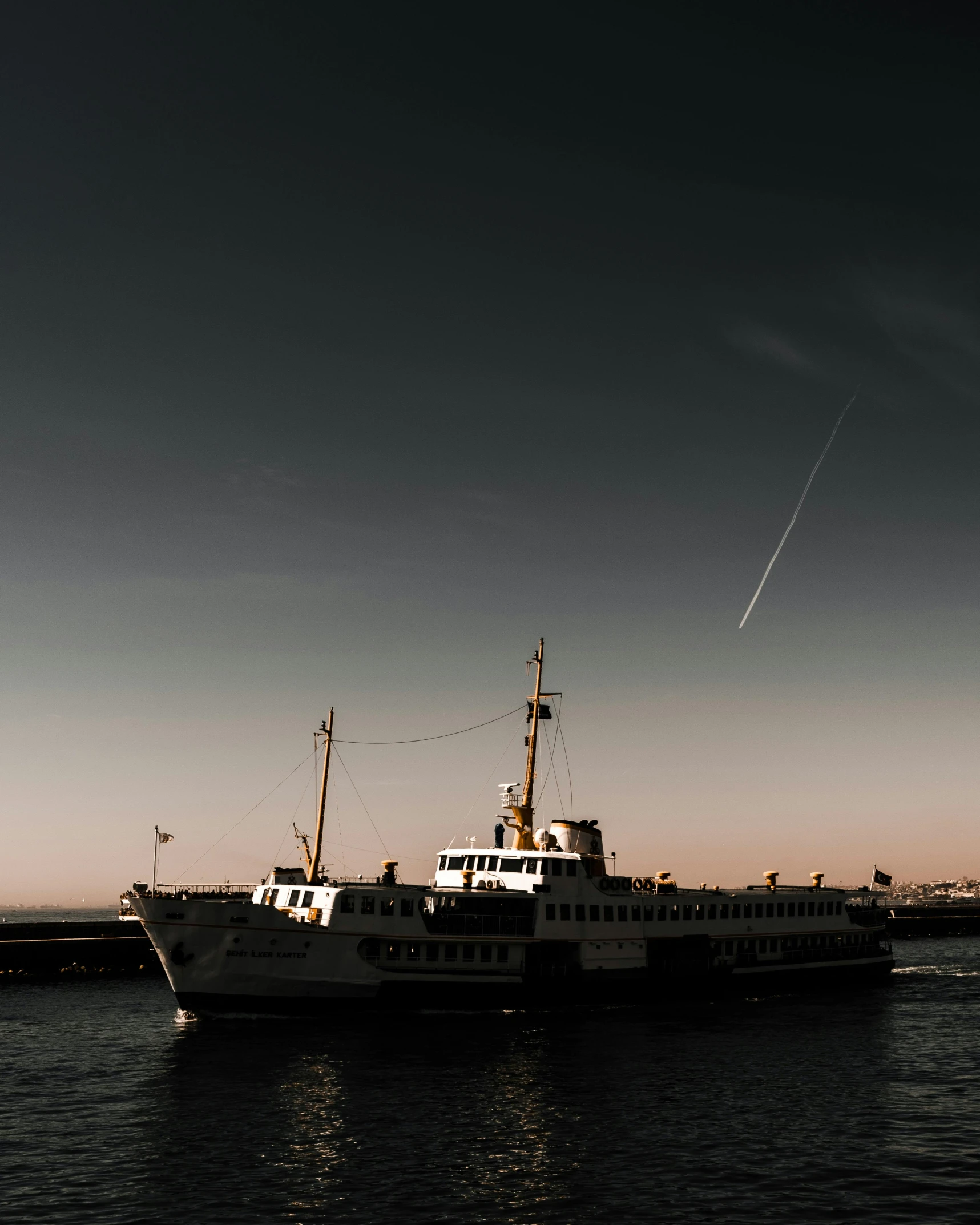 a large ship on a river with blue sky in the background