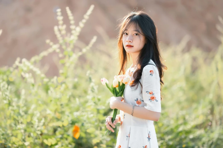 a little girl that is holding a bunch of flowers