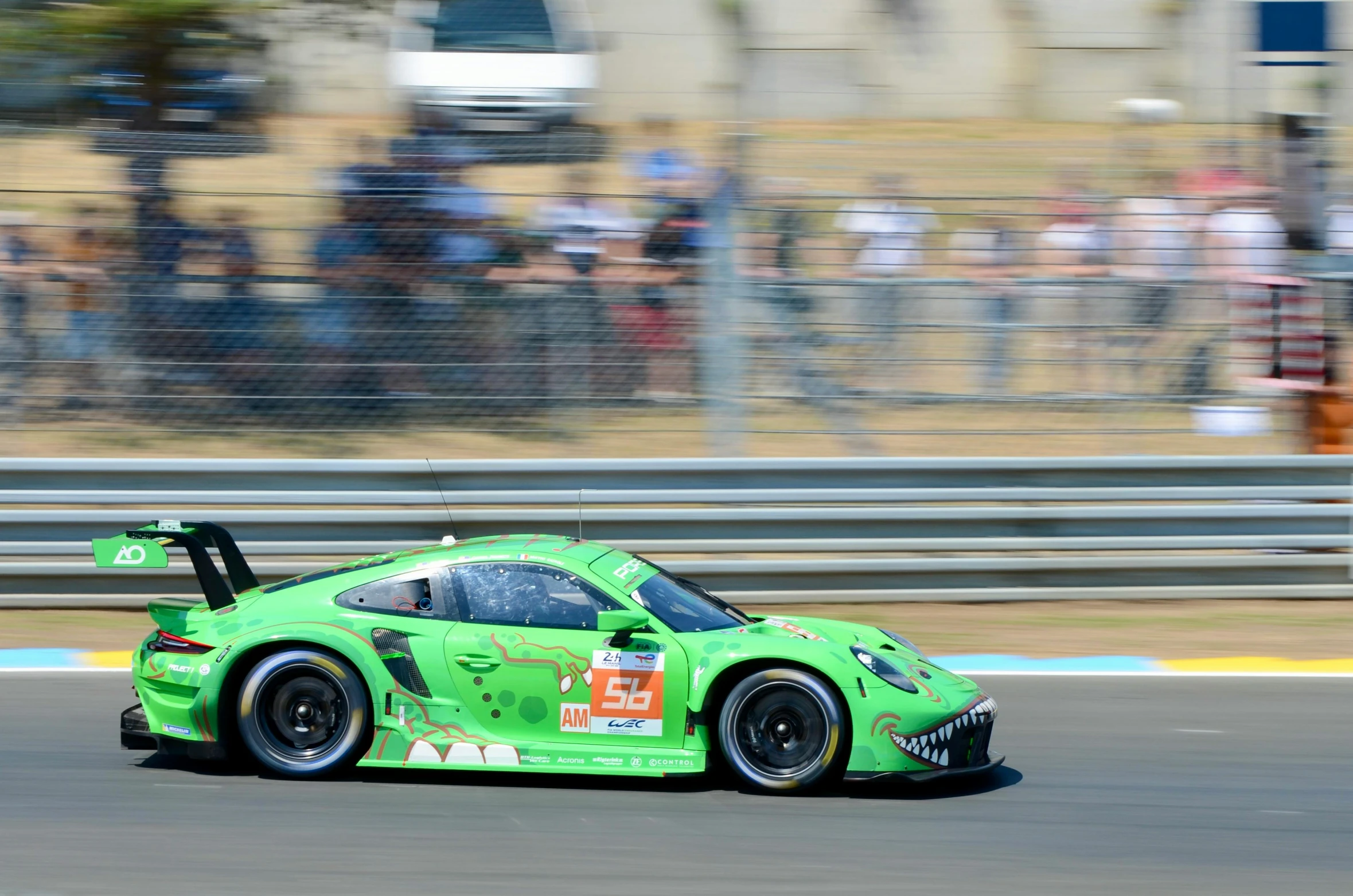 a green sports car racing on a racetrack