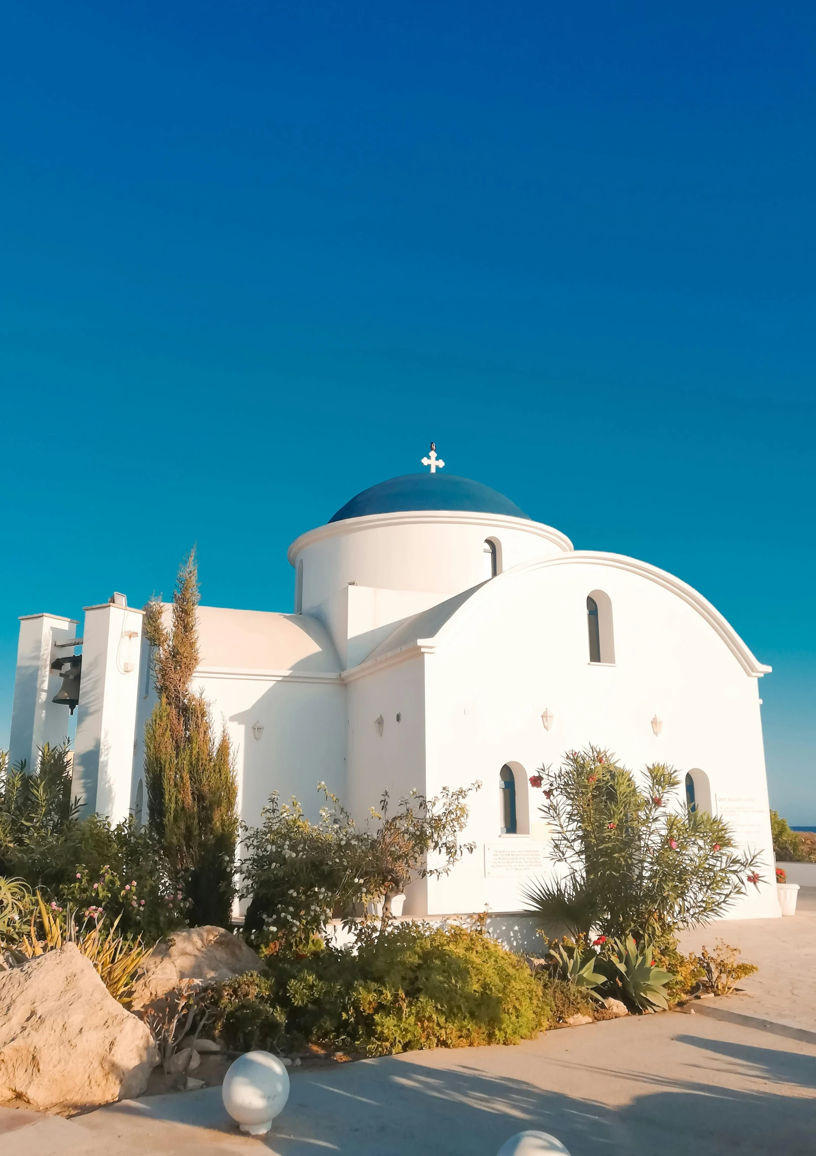 a white church that has a cross on the top