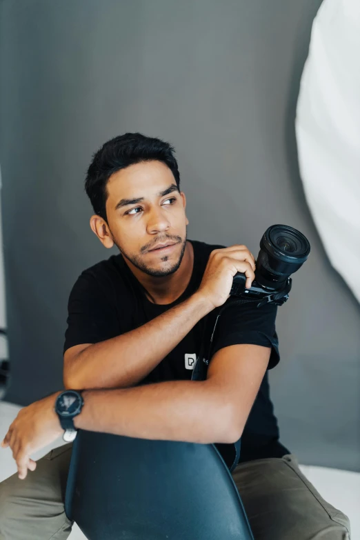 a man in a black t - shirt and some gray pants