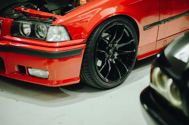 a red car with an open hood on it's engine