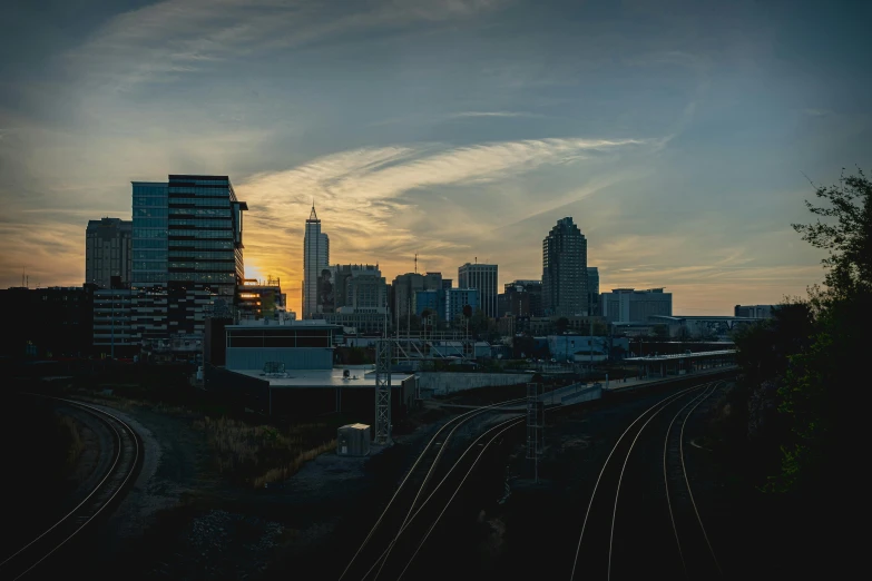 some tall buildings and a lot of train tracks