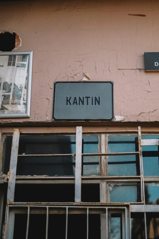 a pink building with some signs above it