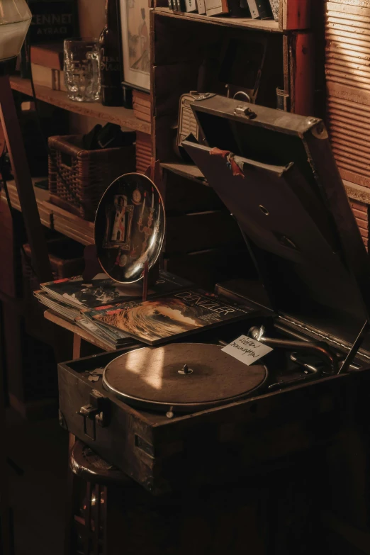 a old record player with a lot of junk next to it