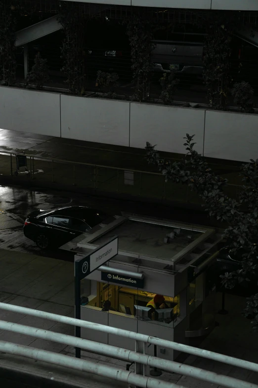 the parking meter is beside of an outdoor pool at night