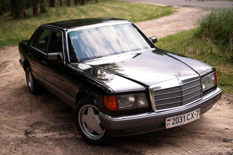 the black mercedes benz parked on the side of the road