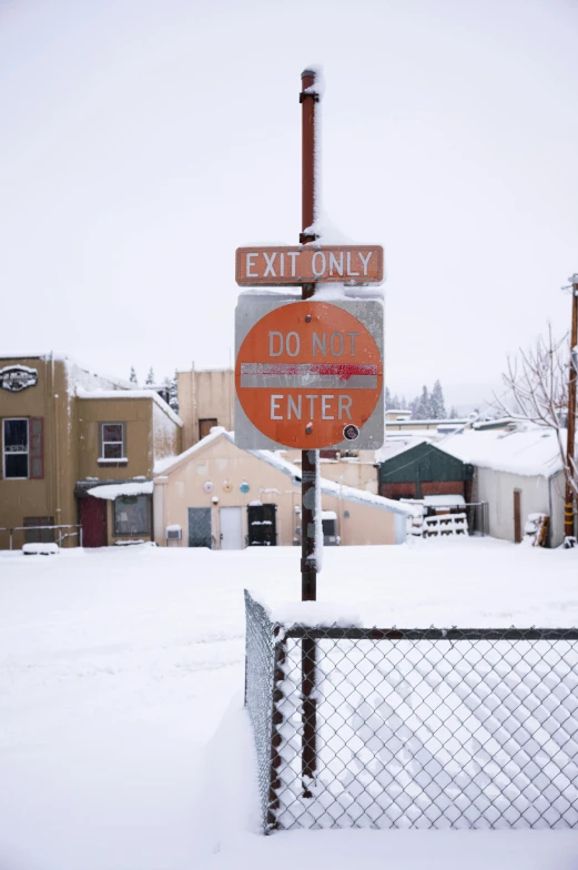 a metal fence with signs attached to it