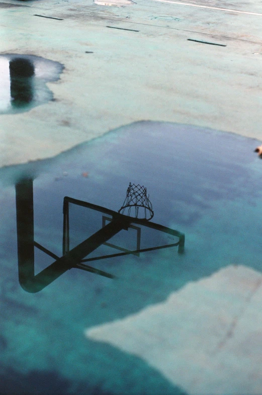 an upside down picture of a blue umbrella and a water fountain