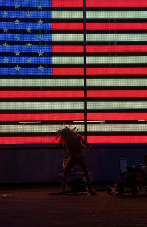 two workers working next to an american flag sign