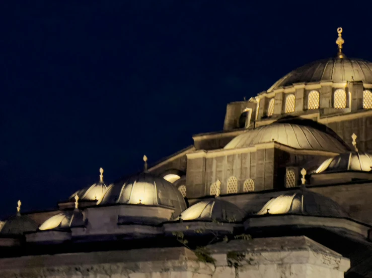 the dome on the building has many lights shining on it