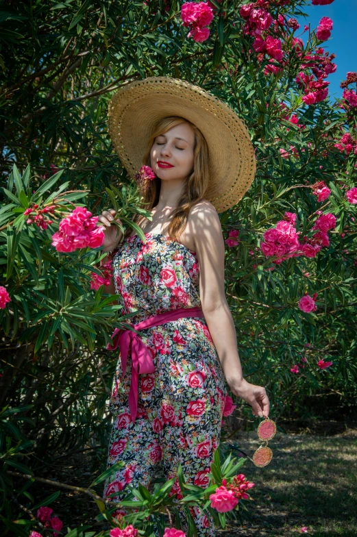 a woman in a sun hat in the middle of a garden