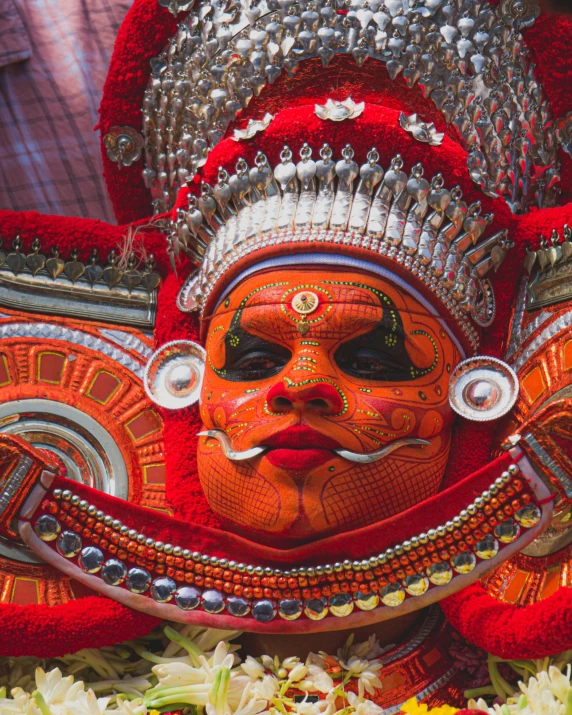 an intricate face painting with head jewels on top