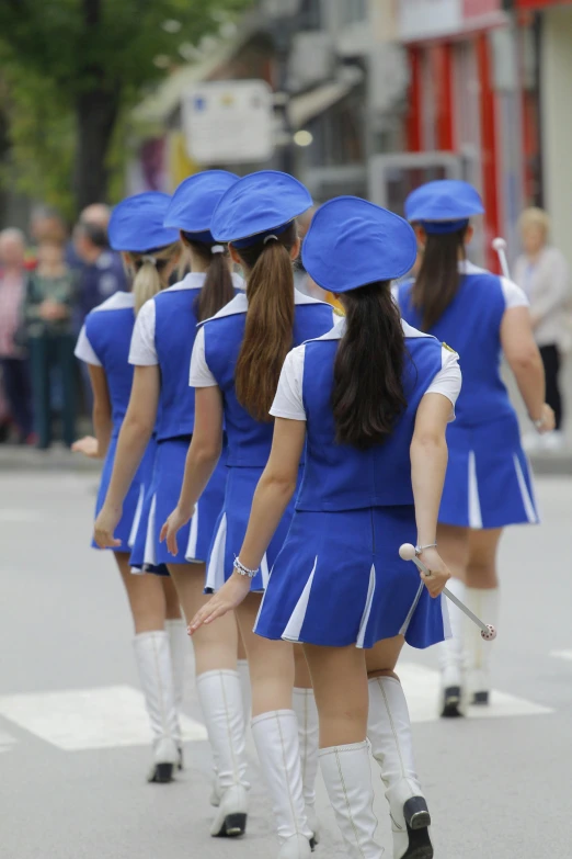 a bunch of women are walking down the street