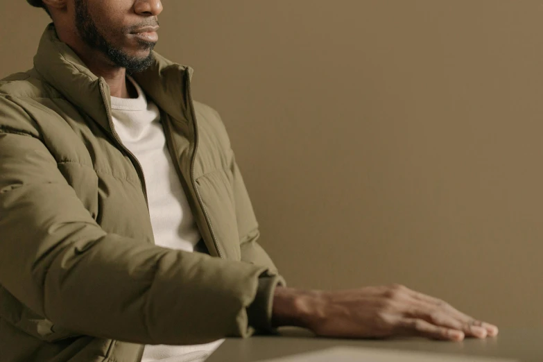 a man with his hands resting on a desk