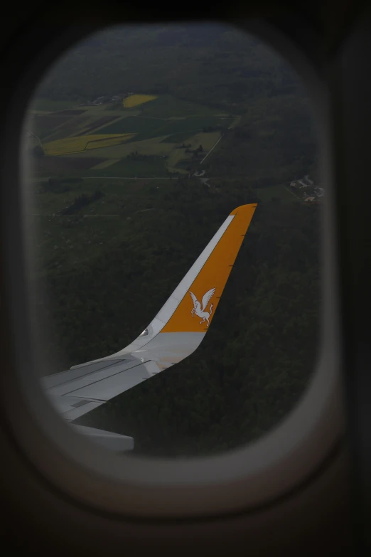 the wing of a large commercial plane in the sky