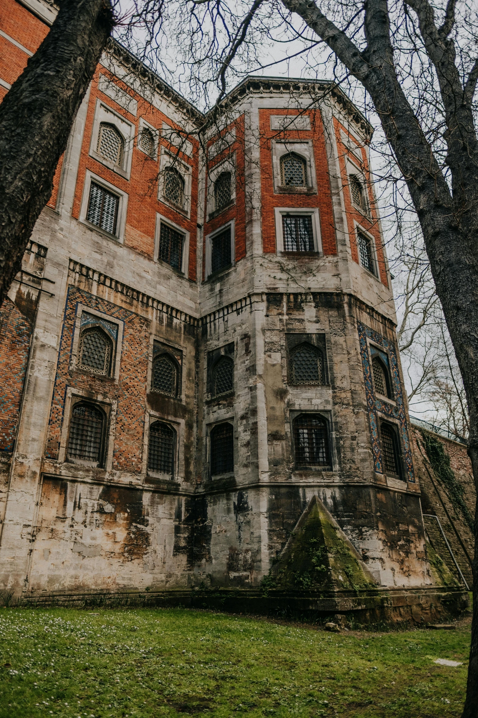 a very old and run down house with a clock