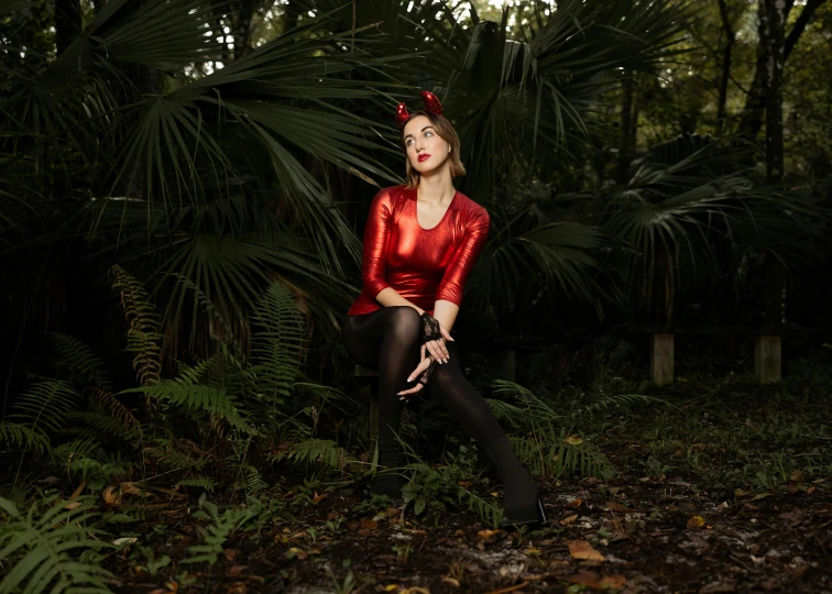 a woman with her eyes closed, wearing a red top and black stockings and stockings and tights