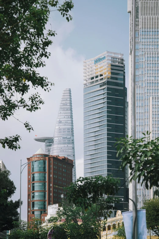 a couple of very tall buildings with lots of trees