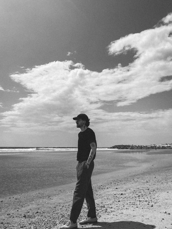 a young man is on a beach near the ocean