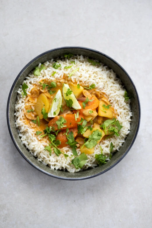 a bowl of food with rice and various vegetables