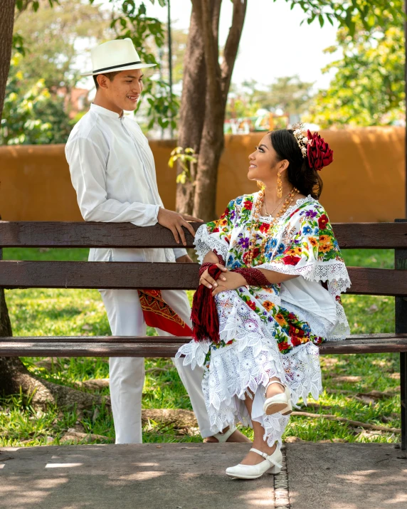 a man and woman sit on a park bench