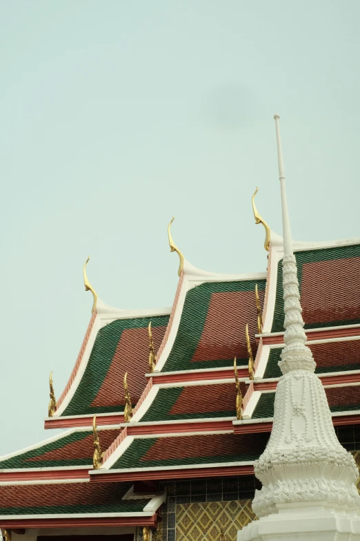 ornate white spires in a temple with green roof