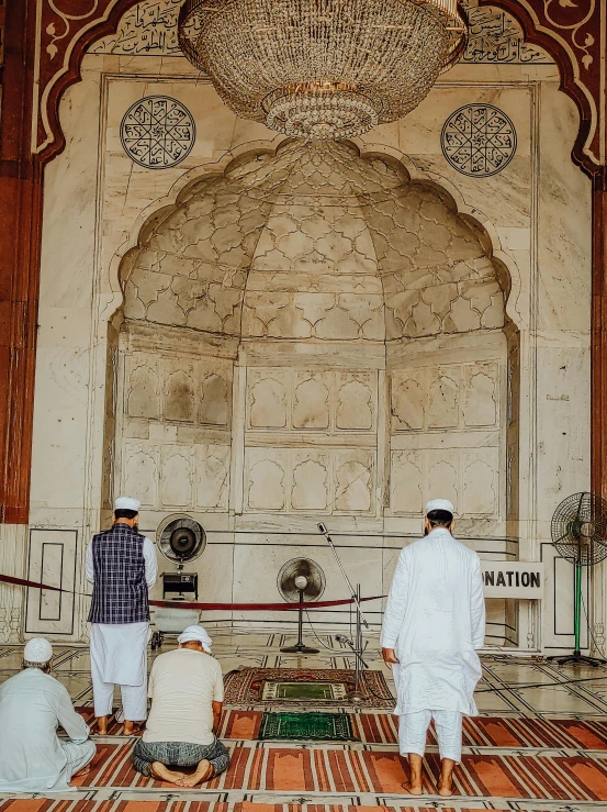 a man stands on a floor near an elaborate arch