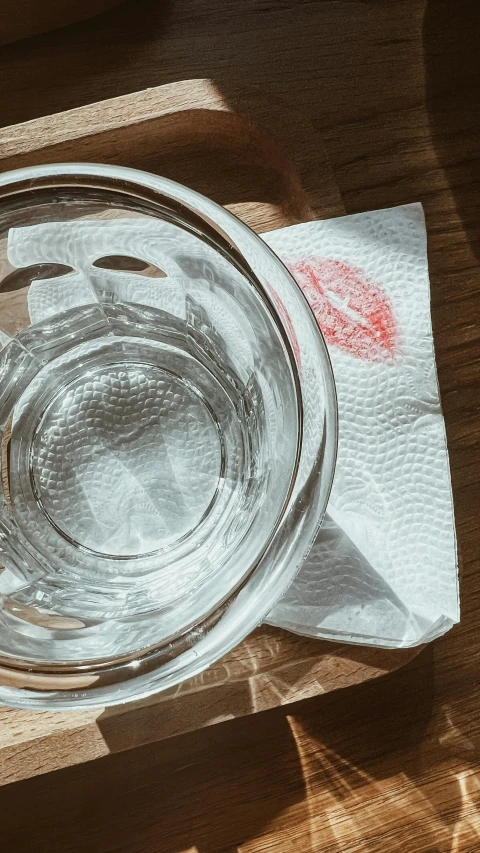 an empty glass dish on top of a wooden table