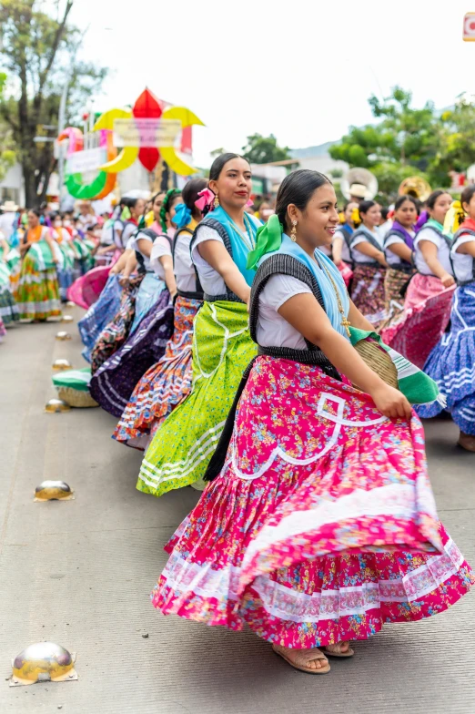 colorfully dressed dancers in the middle of the street