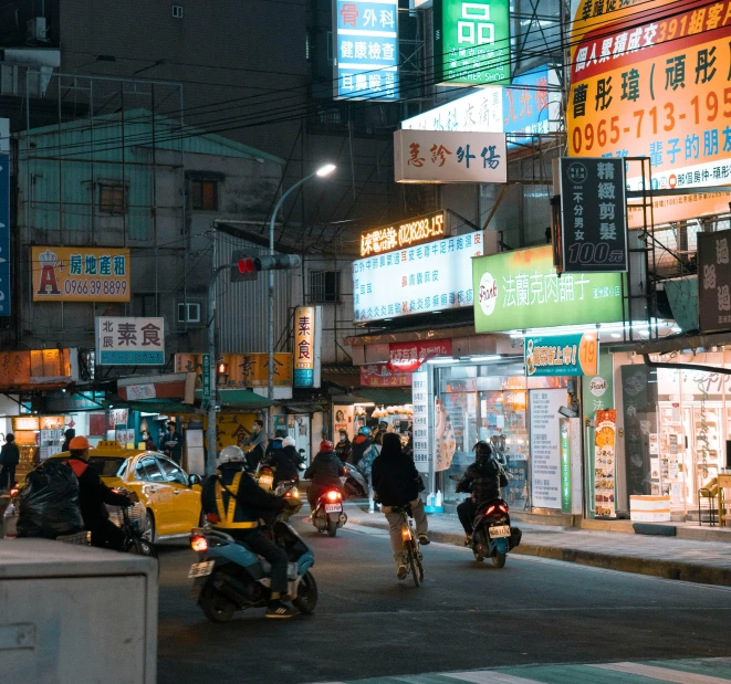 motorcycles driving down the road at night time