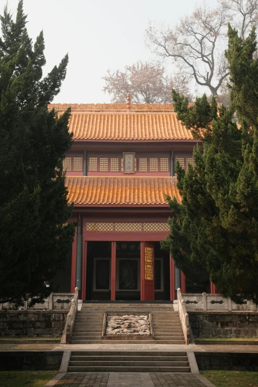 an old building with red and yellow roof and stairs