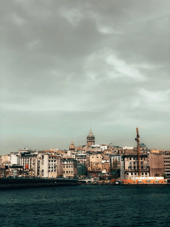 the city is on a cloudy day by the water