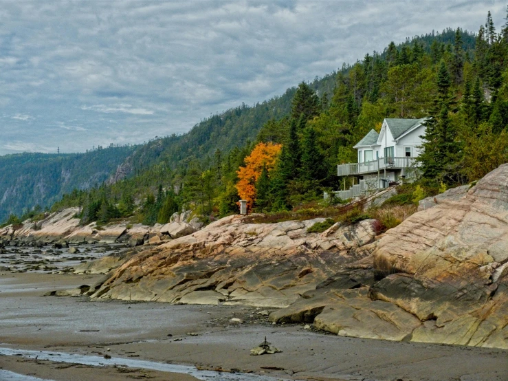 a beach house with trees in the background