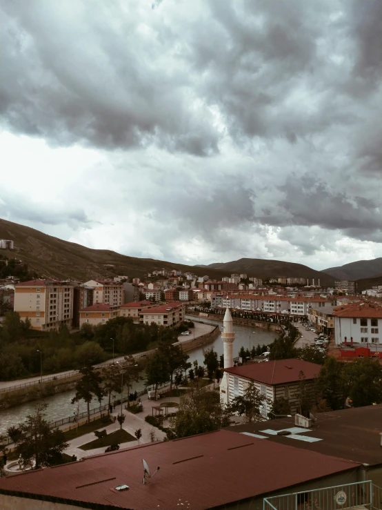 the view of a city, overlooking water and mountains