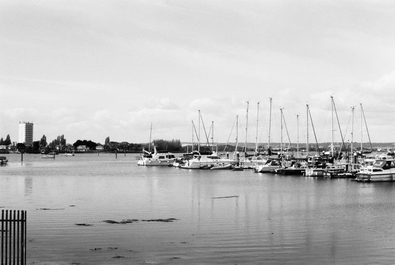 a black and white pograph of sailboats in a harbor