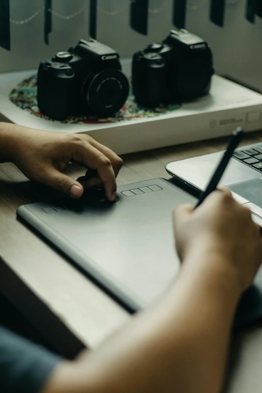 a person is working at a desk with several laptops