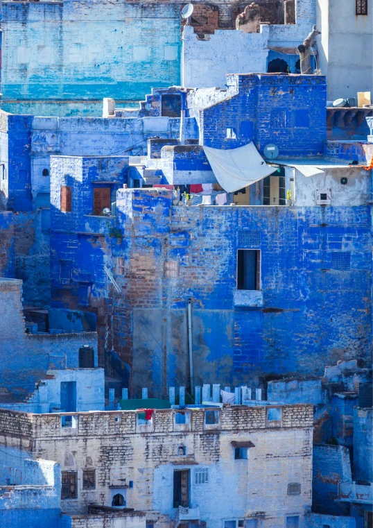 blue walls surround a white building in a city