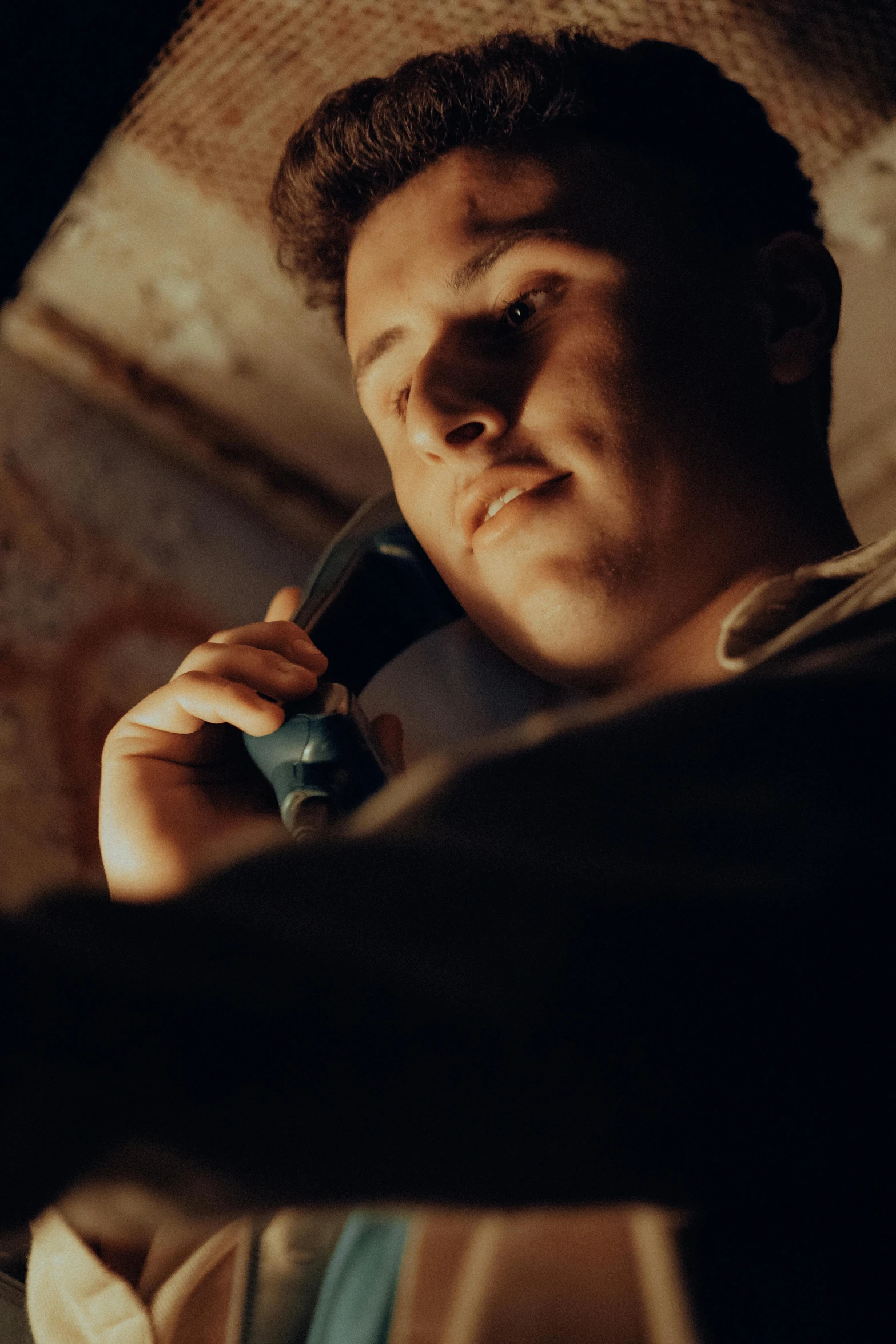 a young man is talking on a cellphone