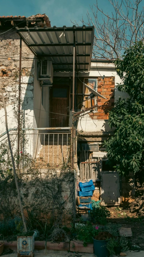 an old house is next to a tree